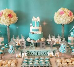 a table topped with lots of cakes and desserts