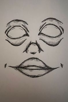 a drawing of a man's face with eyes and nose drawn in pencil on paper