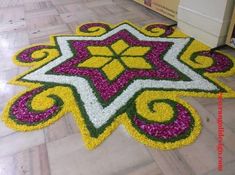 a large flower arrangement on the ground in front of a door