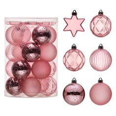 pink and silver ornaments are in a glass container