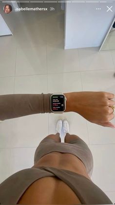 a person with an apple watch on their wrist is standing in front of a mirror