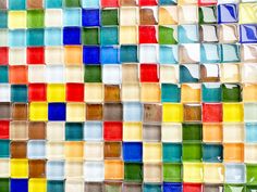 multicolored glass tiles are arranged on the wall