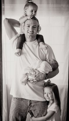 a black and white photo of a man holding a baby in his arms with the caption save