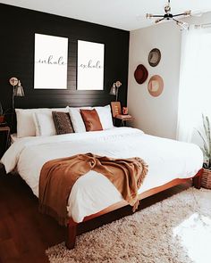 a large bed sitting in a bedroom on top of a wooden floor next to a window