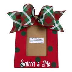 a red and green frame with a bow on the top that says santa & me