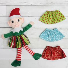 an elf doll and two skirts on a white background