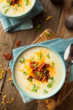 two bowls of soup with bacon and cheese