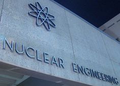 the sign for nuclear engineering is lit up at night