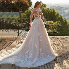 a woman in a wedding dress standing on a deck