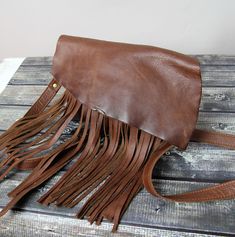 Small Crossbody Hipster Rustic Brown Leather Fringe Bag Vintage Button. Tassel Shoulder Bag ,Bohemian Women bag,western fringe purse Dimensions: height:15 cm (6 in) max width: 21,5 cm (8 in) strap: max 130 cm (51 in) Hobo bag made from genuine first class dark brown leather. It is made from high quality distressed leather. This leather bag can be used as a tote and messenger bag. By using the adjustable leather strap you can convert it into a crossbody bag. The flap by the bag will be able to di Western Bag, Leather Fringe Bag, Western Purses, Fringe Purse, Bohemian Women, Fringe Bags, Rustic Brown, Leather Fringe, Bag Vintage