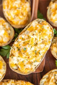 an image of baked potatoes with cheese and herbs in them on a cutting board text reads, million dollar twice baked potatoes