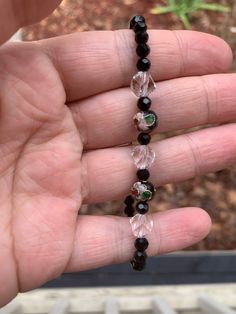 This bracelet is made with stretchy cord so it can be worn on many different sized wrists! What a gorgeous, unique bracelet! Flower Beaded Bracelet, Unique Flower, Unique Bracelets, Unique Flowers, Black Crystals, Wire Wrapped Jewelry, Beaded Flowers, Clear Crystal, Beaded Bracelet