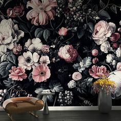 a large floral wallpaper with pink and white flowers on it in a living room