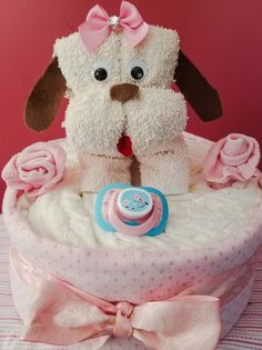 a stuffed dog sitting on top of a cake