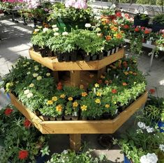 several tiered planters filled with different types of flowers