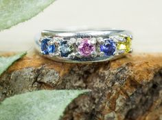 "This is a beautiful set of Multicolor \"Rainbow\" Sapphires from Sri Lanka set in your choice of Sterling Silver or Gold. All of the stones in this piece are natural and untreated with a nice luster, and great clarity.  Yellow Sapphire - 0.150cts Pink Sapphire - 0.125cts Green (multicolor) Sapphire - 0.135cts Purple Sapphire - 0.125cts Blue Sapphire - 0.155cts This nicely sized set of 3mm Round Cut Sapphires weigh 0.555 cts total and will go with any style or occasion and will be sure to make people look your way!  If you have any questions, please feel free to ask!" Rainbow Multi-stone Round Sapphire Ring, Rainbow Multi-stone Sapphire Jewelry, Rainbow Sapphires, Purple Sapphire, Gem Ring, Blue Band, Yellow Sapphire, Simple Jewelry, Pink Sapphire