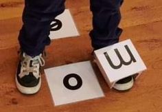 someone standing on top of two blocks with the letters u and o