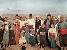 an old photo of people standing together in the desert