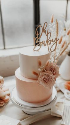 a white and pink cake sitting on top of a table