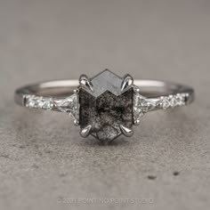 a close up view of a diamond ring with white diamonds on it's sides