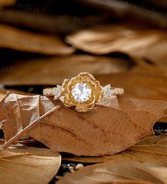 a gold ring sitting on top of a leaf