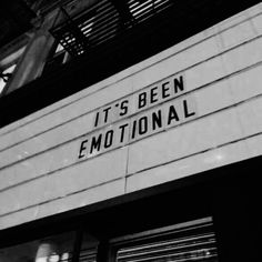 a black and white photo of the outside of a building with an inscription on it