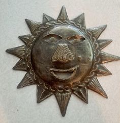 Low Cost Shipping Within The USA, and I will Ship Worldwide At Buyer's Expense Up For Your Consideration  Is a Handmade Recycled Sun Face Metal Art Sculpture  Handmade Recycled Metal "SUN FACE" Sculpture  Haitian Art  Wall Display Made from steel drums by Haitian craftspeople in the section of Port-au-Prince, Haiti called Croix des Bouquets, this sun face is dimensional artpiece with a diameter of 9 inches.  Made in Haiti. This is a One-of-a-kind unique & original handmade metal art in the form of a sun face. Artist unknown The metal artwork is in excellent condition, is quite unique and displays  as it displays a Sun Face, the art piece is showing this piece in it's natural patina state. This art piece is handcrafted from a recycled steel oil drum, which is flattened and then cut out with Art Wall Display, Art Display Wall, Haitian Metal Art, Face Sculpture, Metal Art Wall, Haitian Art, Oil Drum, Steel Drum