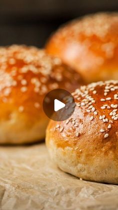 three sesame seed bagels sitting on top of a table