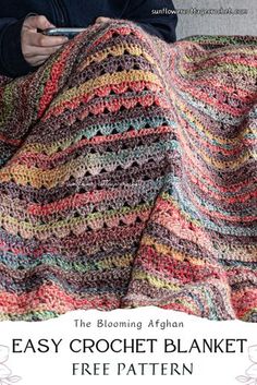 an easy crochet blanket with text overlay that reads, the blooming afghan