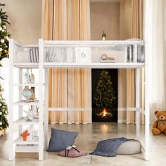 a white bunk bed sitting next to a christmas tree