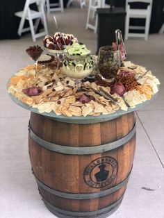 a wooden barrel filled with food and drinks