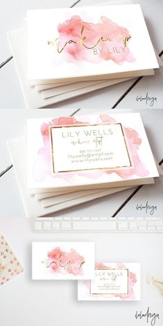 business cards with watercolor flowers and gold foil on them, sitting next to a keyboard