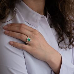 A vibrant emerald wrapped in a lovely diamond bodice. Materials - 18k yellow gold, Columbian Emerald, Diamond Weights - 1.15ct Emerald, 0.76ct Diamond Size﻿ - 6.5 Green Diamond Birthstone Ring With Brilliant Cut, 14k Gold Green Emerald Ring With Brilliant Cut, Green Emerald Ring With Halo Setting, Baguette Cut, Luxury Emerald Green Birthstone Ring, Green Baguette Cut Emerald Ring With Halo Setting, Columbian Emeralds, Emerald Diamond, Diamond Sizes, Emerald Ring