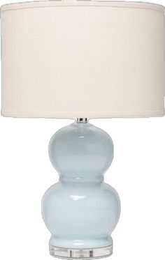 a light blue glass lamp with a white shade