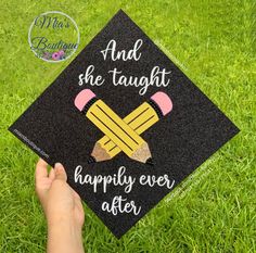 someone is holding up a graduation cap that says, and she taught happily ever after