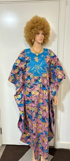 This stunning African ankara dress is the perfect addition to your wardrobe. Made from high-quality cotton and featuring a beautiful geometric pattern, this dress is ideal for any occasion, from weddings to casual outings. The dress has a scoop neckline and short sleeves, making it comfortable and stylish. The dress length is long, adding an elegant touch, and it comes with a pullover closure for ease of wear. This dress is perfect for all seasons, especially summer and spring, and comes in a be Blue Long Sleeve Ankara Dress, Traditional Patterned Tunic Dress, Festive Patterned Dresses With Floral Print, Festive Patterned Cotton Dresses, Traditional Multicolor Ankara Kaftan, Traditional Multicolor Ankara Fabric Kaftan, Traditional Purple Floral Print Dress, Festive Purple Cotton Dress, Festive Multicolor Batik Print Dress