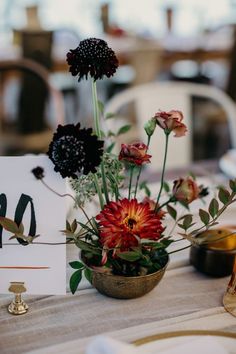 a table with flowers and cards on it