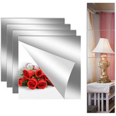 a bunch of red roses sitting on top of a white table next to a lamp