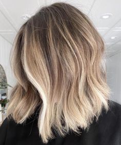 the back of a woman's head with blonde hair and light brown to blond highlights