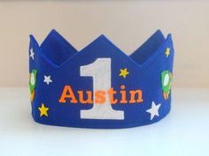 a blue crown with the number one on it and stars around it, sitting on a table