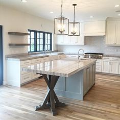 a large kitchen with an island in the middle