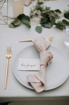 a white plate topped with a napkin and fork