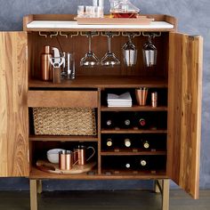 a wooden cabinet filled with lots of bottles and glasses