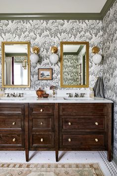 a bathroom with two sinks, mirrors and wallpapered walls in the background is an antique style vanity