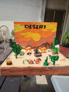 a desert scene made out of clay with fake cactus and cacti on it