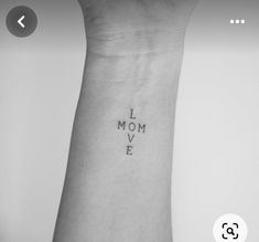 a wrist tattoo with the words i love mom on it