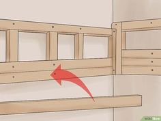 a wooden bunk bed with a red arrow pointing to the bottom and side rails on it