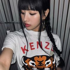 a woman with black hair wearing a tiger t - shirt