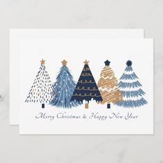 a card with three christmas trees on the front and one is blue, gold and white