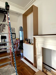 a living room filled with furniture and a fire place next to a fireplace covered in american flags